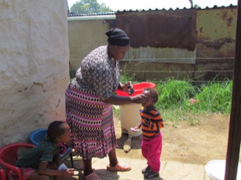  Lerato 3 years old being given Vitamin syrup by Nokuthula 